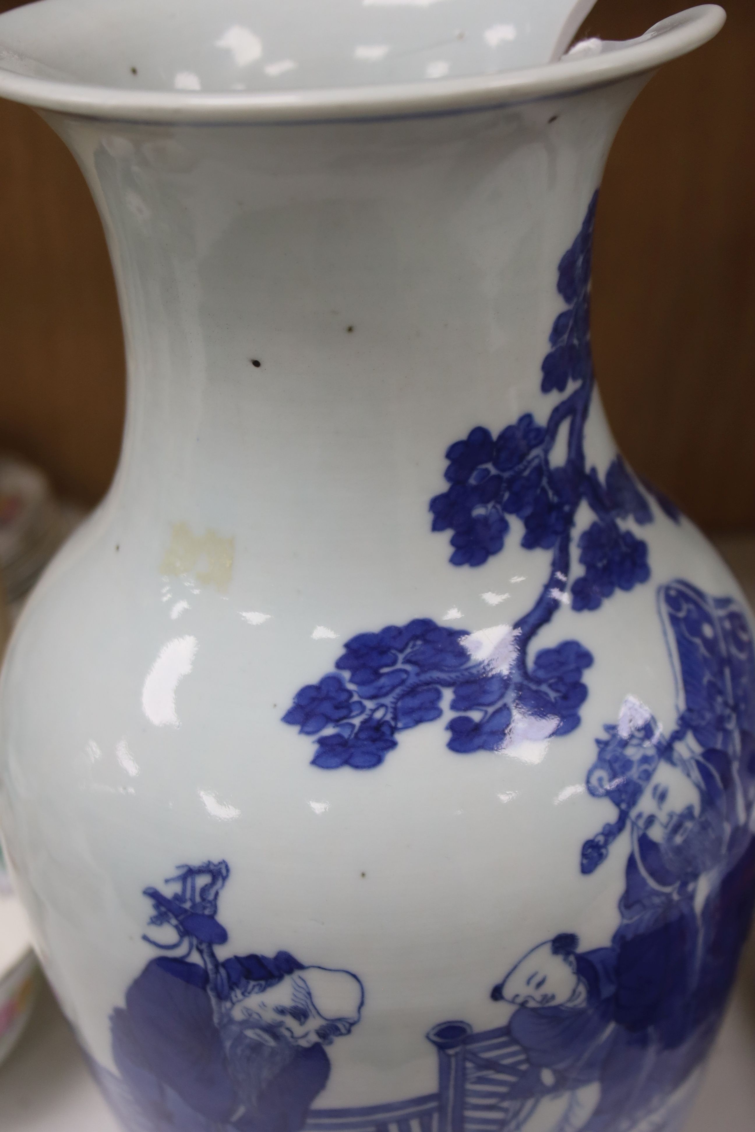 A Chinese blue and white 'Immortals' vase, 18th/19th century, damage, 34.5cm and a Chinese Yongzheng period famille rose ‘phoenix’ vase (reduced in height), 24cm